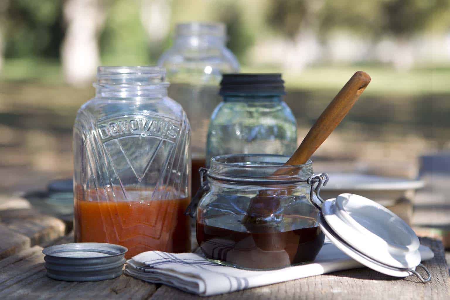 Basic hickory BBQ sauce in a mason jar with a brush beside it.
