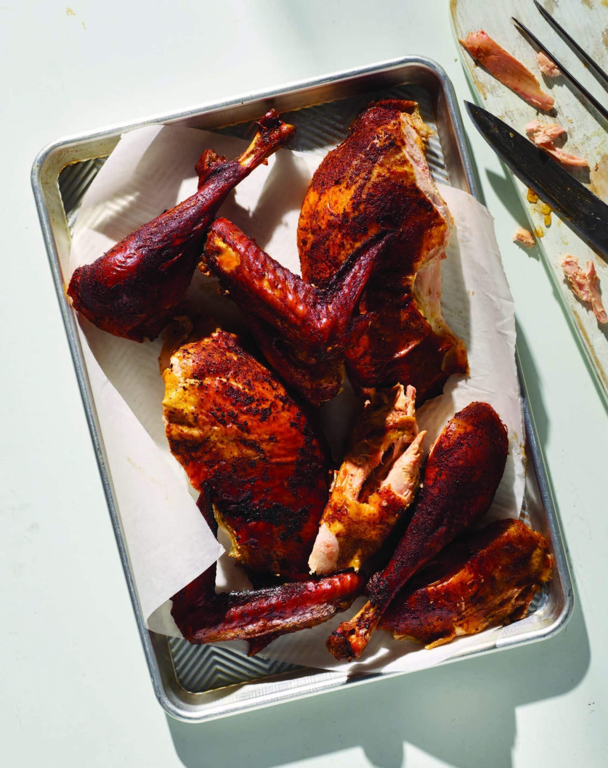 Smoked butterflied turkey with crispy skin on a cutting board