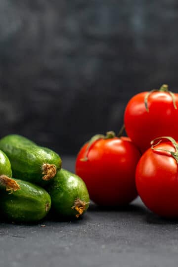 Baked tomato, onion, and zucchini casserole with golden cheddar cheese topping.