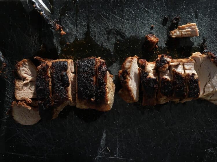Sliced competition pork loin glazed and dusted with BBQ rub.
