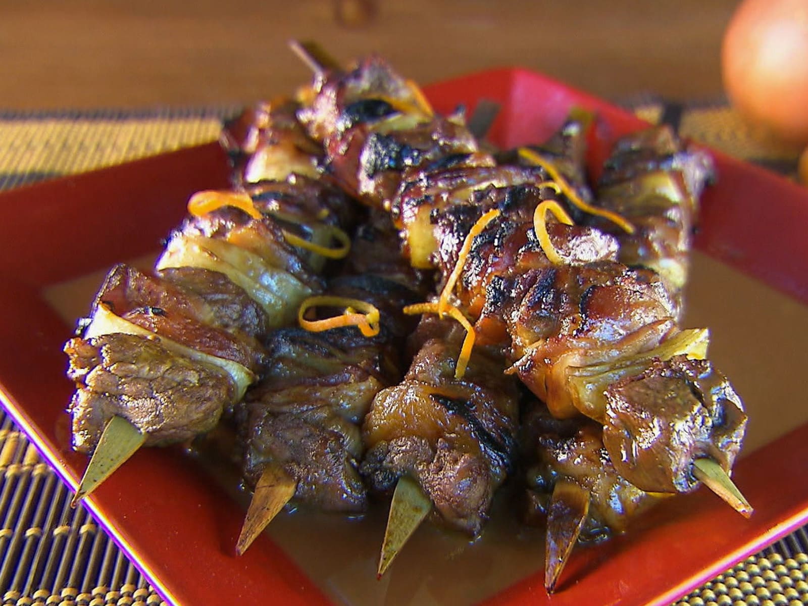 Grilled chicken tikka kebabs on metal skewers, with golden crust and fresh garnish.