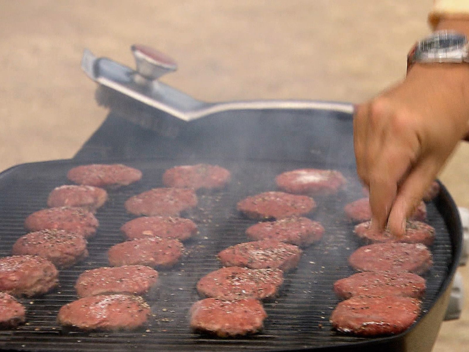 Kobe beef sliders stacked on a wooden board, ready to serve.