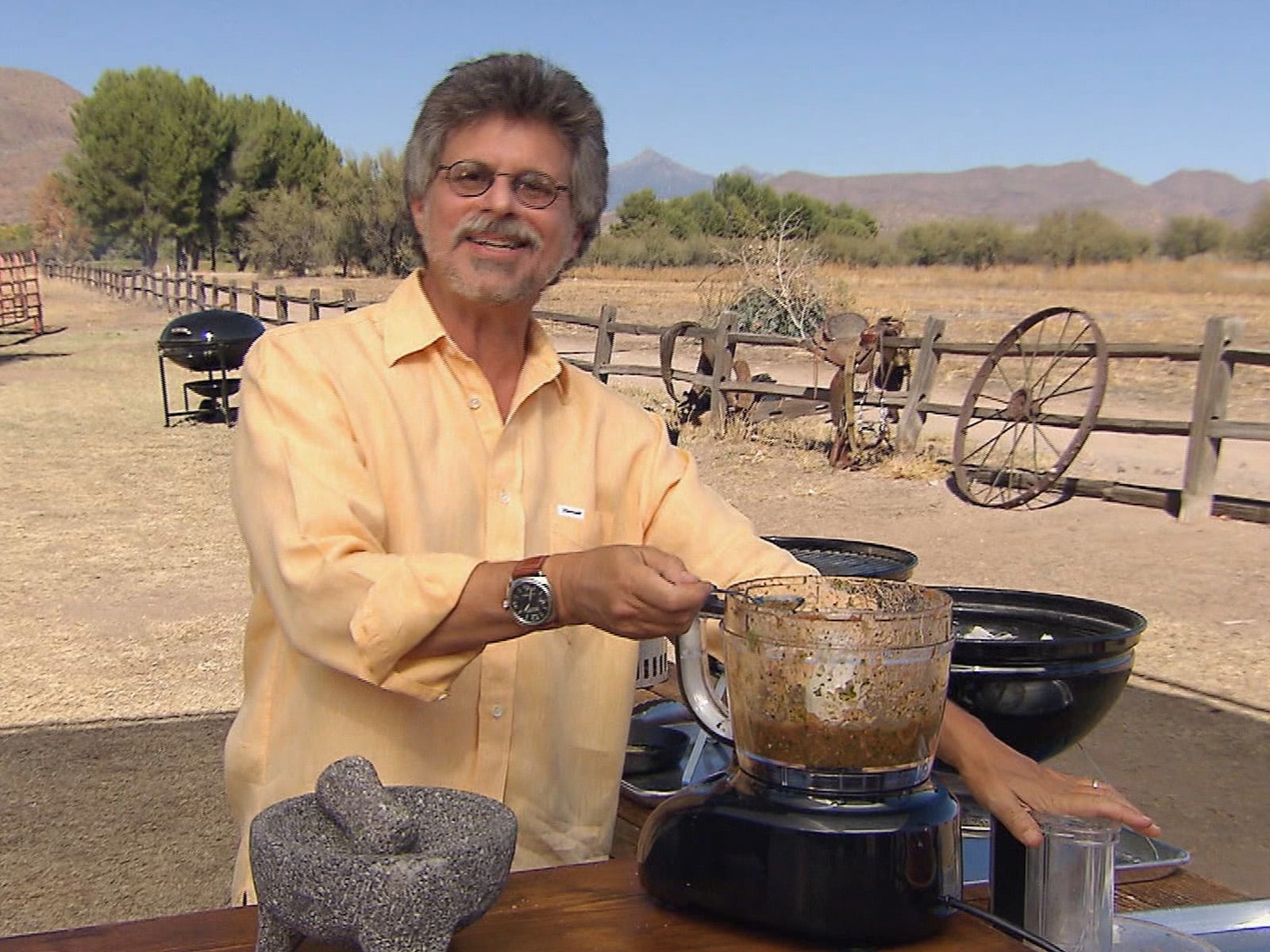 Bowl of smoky grilled tomato and habanero salsa with flecks of charred skin and fresh cilantro.