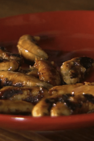 Grilled Thai bananas glazed with coconut caramel sauce on a skewer