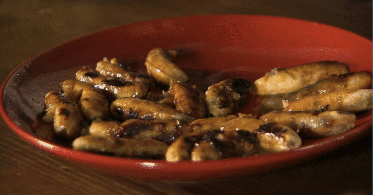 Grilled Thai bananas glazed with coconut caramel sauce on a skewer