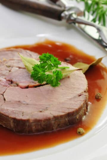 Smoked German Spiessbraten pork loin tied with string and sliced