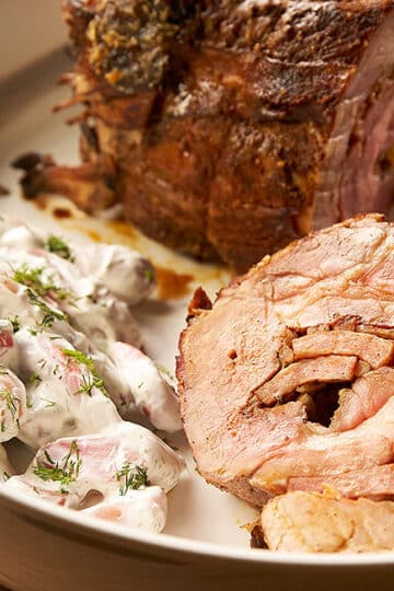 Bowl of creamy radish salad with visible grated radishes and light dressing.