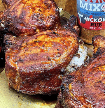 Apple and sausage stuffed pork chops plated with green beans, peppers, and onions.