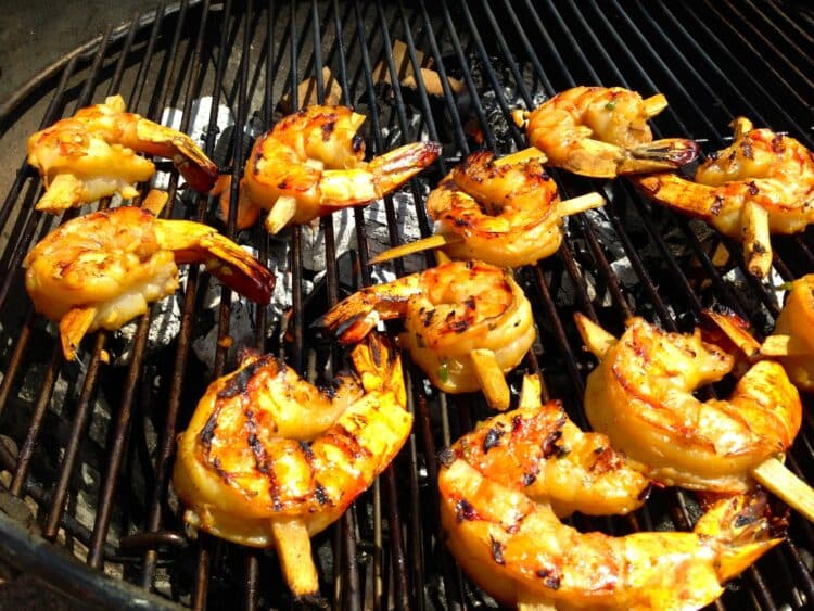 Grilled shrimp skewers glazed with rum and brown sugar on sugarcane sticks