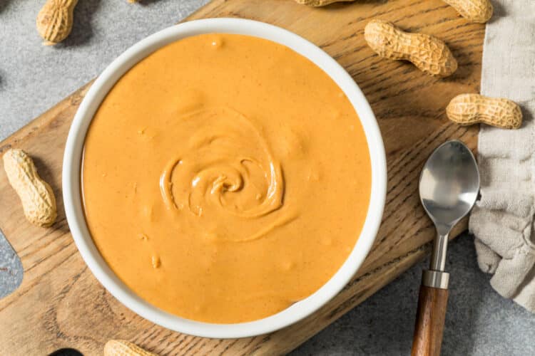 Rich and creamy Singapore peanut sauce in a bowl, topped with fried garlic slices