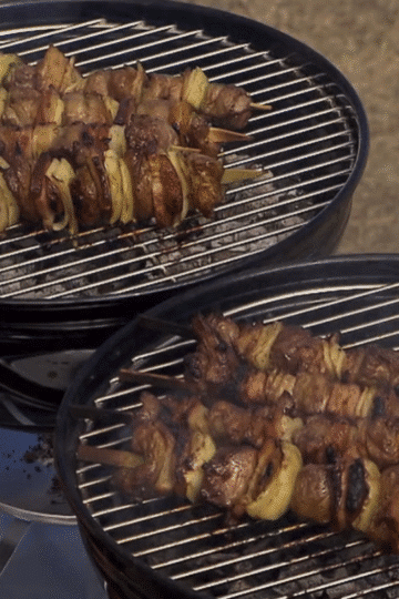 Grilled Cape Malay sosaties on skewers with golden char, glazed with sweet curry sauce.