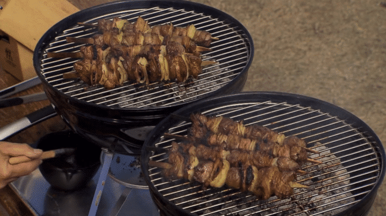 Grilled Cape Malay sosaties on skewers with golden char, glazed with sweet curry sauce.