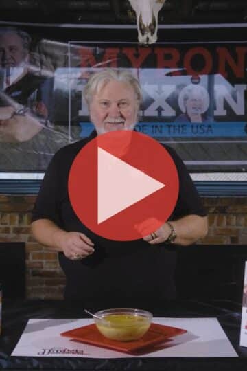 BBQ Pitmaster Myron Mixon standing at his smoker preparing keto chili chicken with smoked thighs