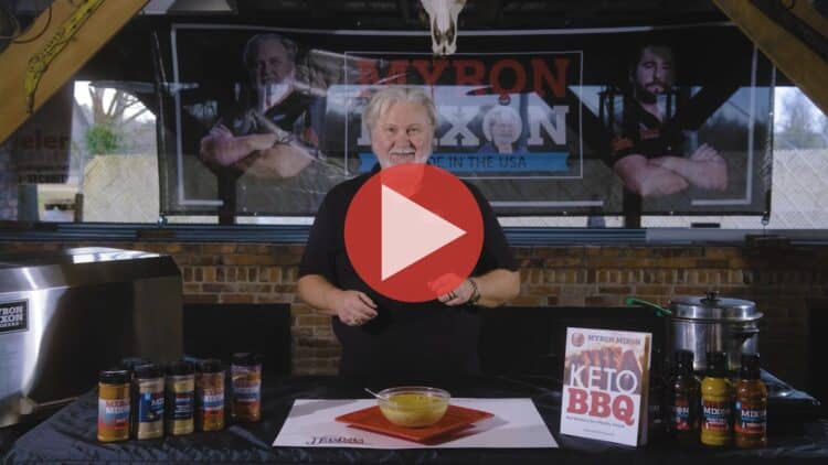 BBQ Pitmaster Myron Mixon standing at his smoker preparing keto chili chicken with smoked thighs