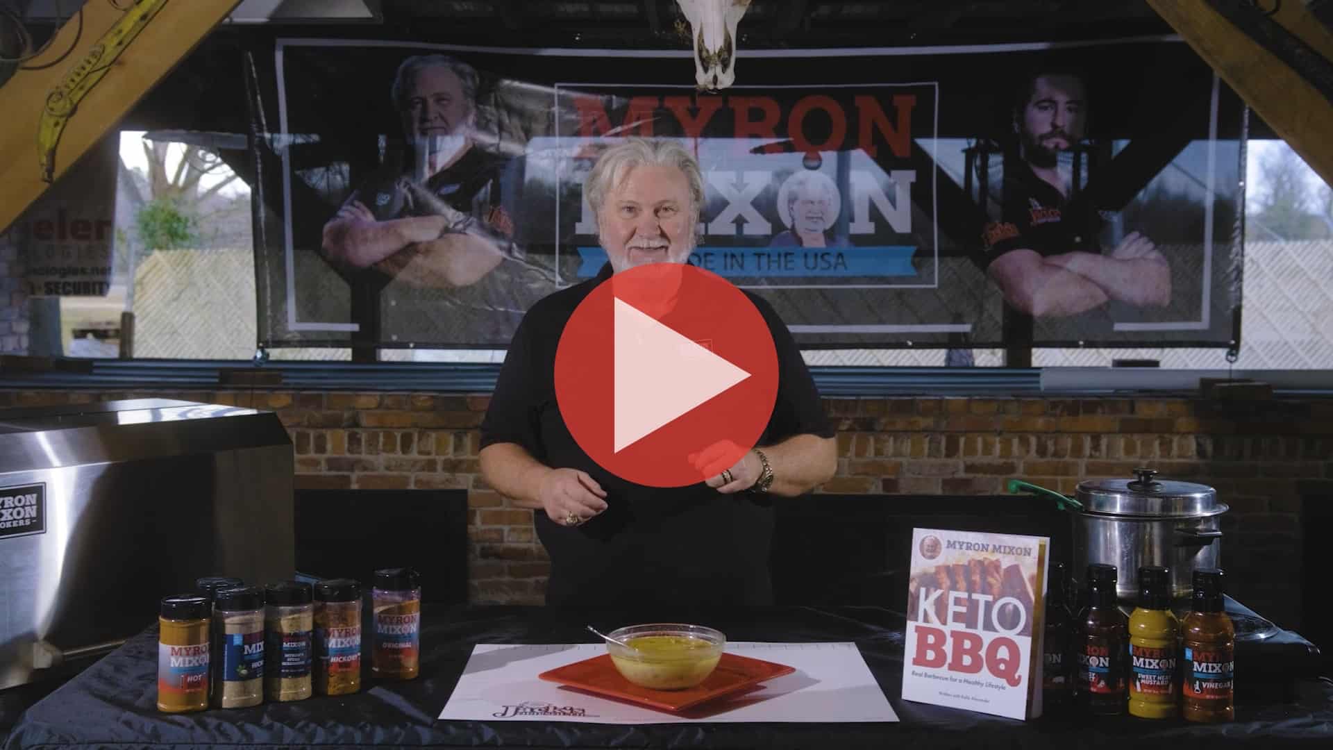 BBQ Pitmaster Myron Mixon standing at his smoker preparing keto chili chicken with smoked thighs