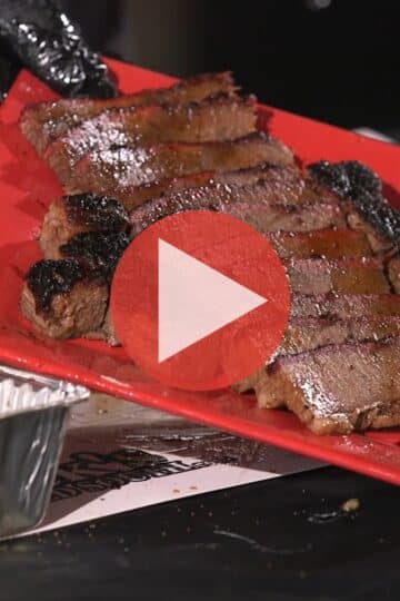BBQ Pitmaster Myron Mixon trimming a large Wagyu brisket on his prep table