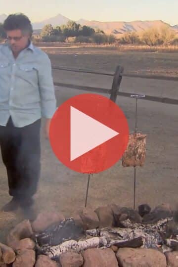 Steven Raichlen grilling beef ribs over open fire in Gaucho Grill