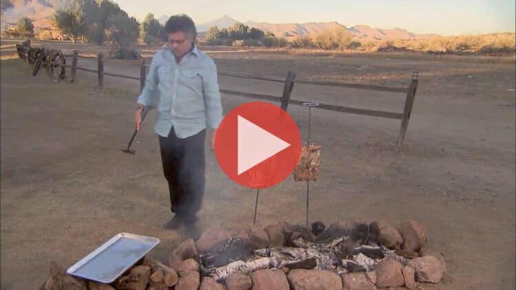 Steven Raichlen grilling beef ribs over open fire in Gaucho Grill