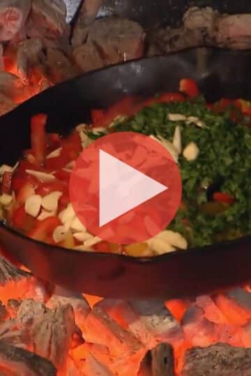 Steven Raichlen cooking over open fire in Primal Grill